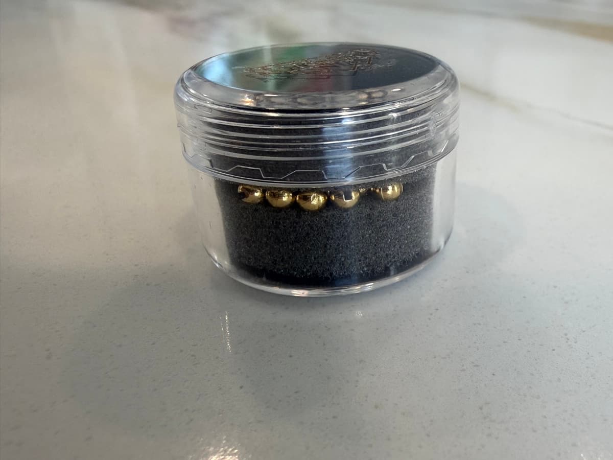 Gold tungsten beads in sealed jar